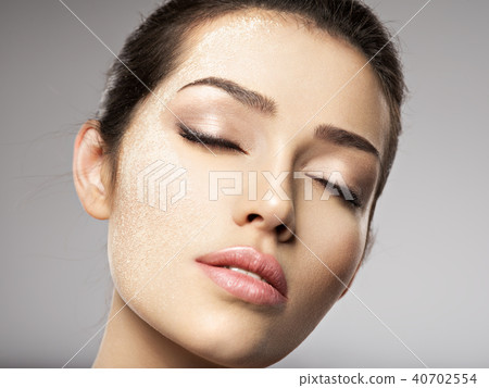 dry cosmetic makeup powder is on the female face. dry cosmetic makeup powder is on the female face. 40702554