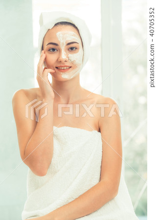 Beautiful woman having a facial treatment at spa. Beautiful woman having a facial treatment at spa. 40705352
