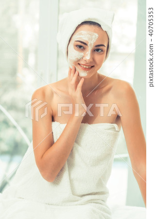 Beautiful woman having a facial treatment at spa. 40705353