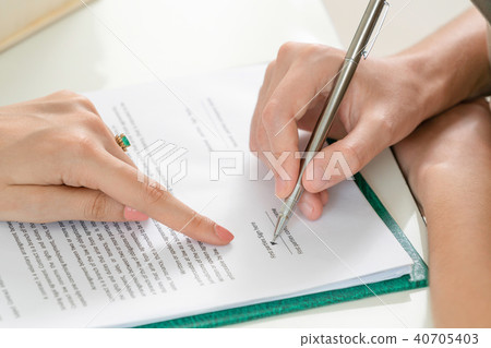 Businesswoman signs agreement contract in office. Businesswoman signs agreement contract in office. 40705403