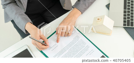 Client Signs Document to Buy House and Real Estate 40705405