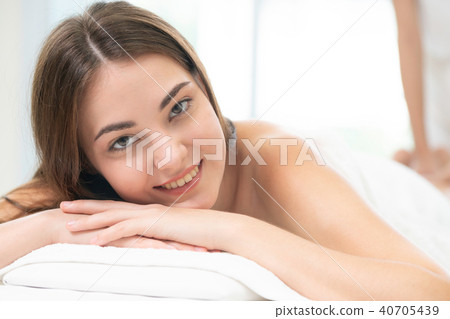 Woman gets back massage spa by massage therapist. 40705439