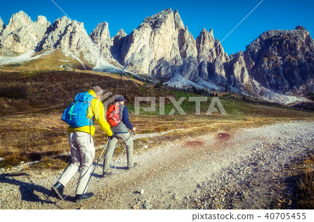Travelers hike breathtaking landscape of Dolomites Travelers hike breathtaking landscape of Dolomites 40705455