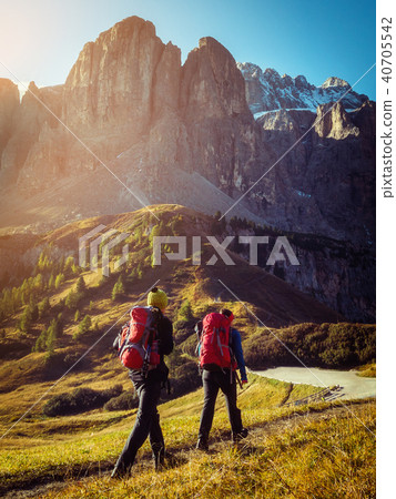 Travelers hike breathtaking landscape of Dolomites Travelers hike breathtaking landscape of Dolomites 40705542