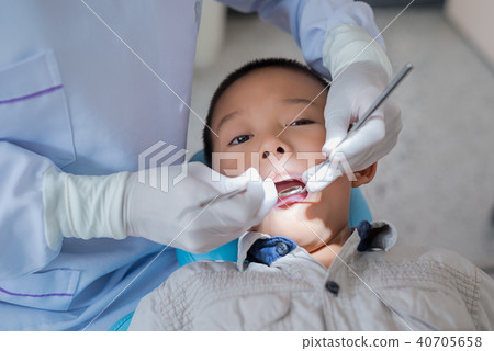 Hands of dentist holding a dental tool. Hands of dentist holding a dental tool. 40705658