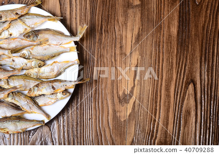 Beer with dried fish and snacks on wooden table Beer with dried fish and snacks on wooden table 40709288