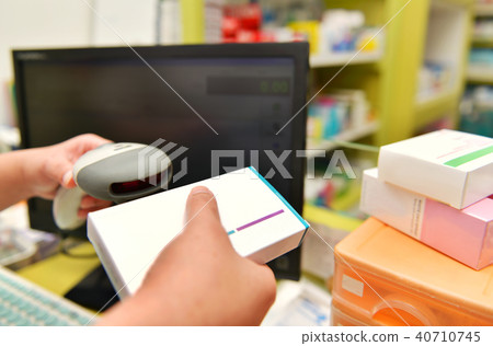 Pharmacist scanning barcode of medicine drug  40710745