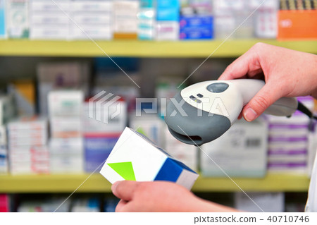 Pharmacist scanning barcode of medicine drug  40710746
