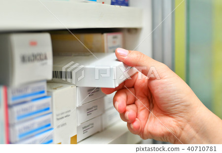 Hand holding medicine box in pharmacy drugstore. Hand holding medicine box in pharmacy drugstore. 40710781