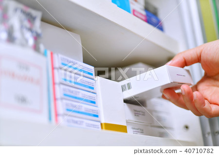 Hand holding medicine box in pharmacy drugstore. Hand holding medicine box in pharmacy drugstore. 40710782