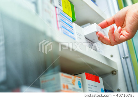 Hand holding medicine box in pharmacy drugstore. Hand holding medicine box in pharmacy drugstore. 40710783