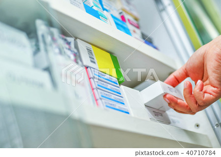 Hand holding medicine box in pharmacy drugstore. Hand holding medicine box in pharmacy drugstore. 40710784
