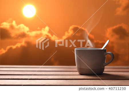 Morning cup of coffee or tea with sunrise Morning cup of coffee or tea with sunrise 40711230