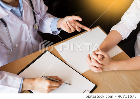 patient listening intently to a male doctor explaining patient s 40711675