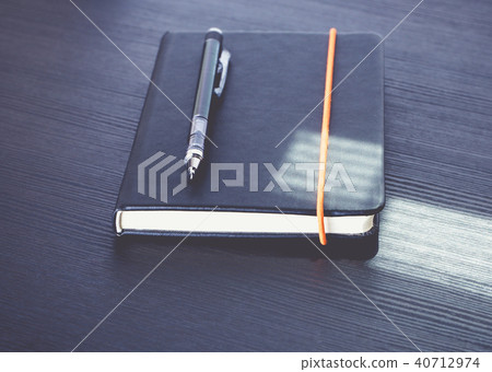Close up black notebook with modern pencil 40712974