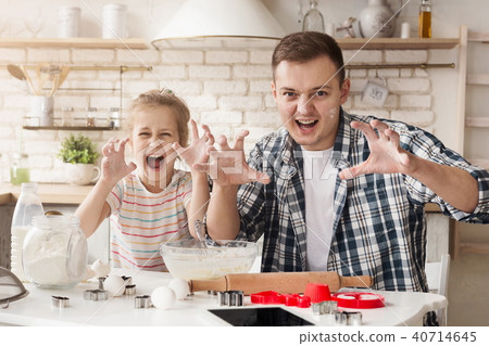 Father and daughter having fun while baking 40714645