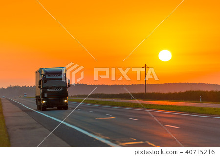 truck on the highway in the rays of the rising sun 40715216