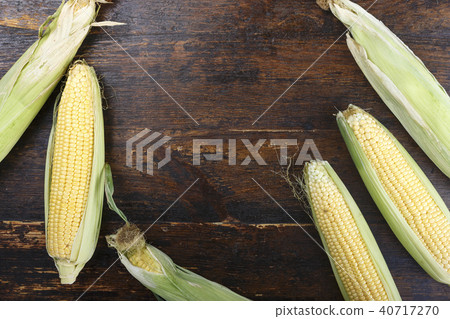 young corn on a wooden background young corn on a wooden background 40717270