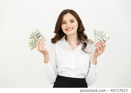 Portrait of a cheerful young business woman holding money banknotes and celebrating isolated over 40717625