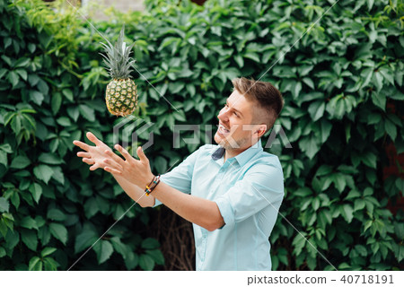 cheerful emotional guy holding a pineapple. 40718191