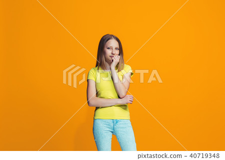 Beautiful teen girl looking suprised and bewildered isolated on orange Beautiful teen girl looking suprised and bewildered isolated on orange 40719348