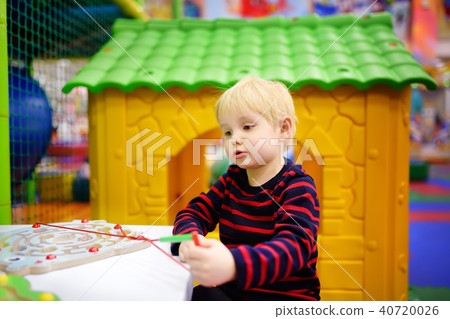 Happy little boy having fun with educational toy in play center Happy little boy having fun with educational toy in play center 40720026