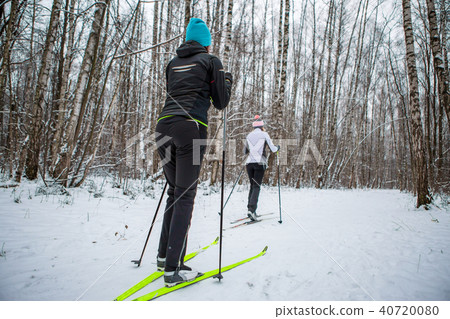 Picture of sports two woman skiing in winter forest 40720080