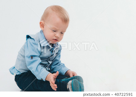 blond boy in blue suit on white background 40722591