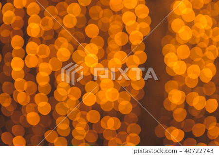 many blurred small electric bulbs on a wall. Yellow blurred lights. Wall of Christmas lights 40722743