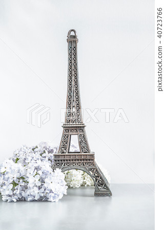 Eiffel tower and lilac flowers on white background Eiffel tower and lilac flowers on white background 40723766