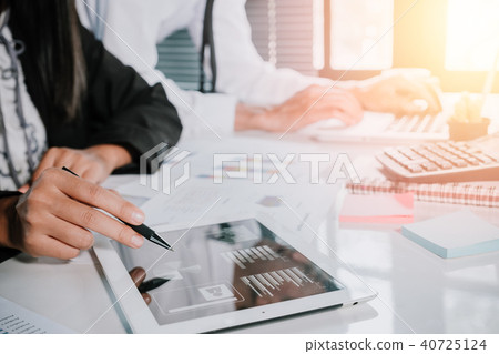 Two young business team using touchpad tablet Two young business team using touchpad tablet 40725124