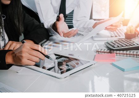 Two colleagues discussing data with tablet 40725125