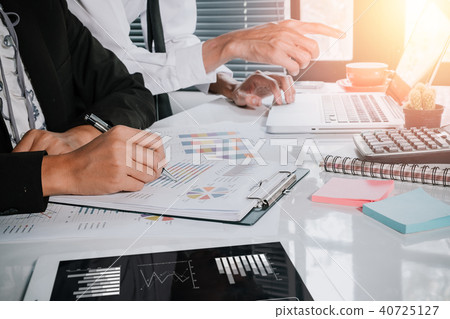 Business team adviser analyzing financial figures Business team adviser analyzing financial figures 40725127