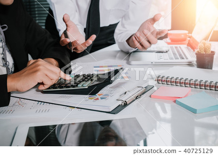 Business team using calculator and laptop computer Business team using calculator and laptop computer 40725129