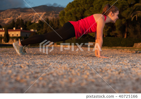 Girl In Leggings And Red Top During Workout 40725166