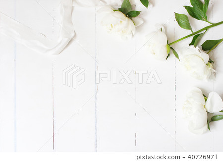 Styled stock photo. Feminine wedding table composition with white peonies flowers and silk ribbon on 40726971