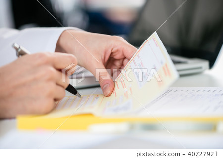 Close-up of the hand of a female patient receiving a prescription Close-up of the hand of a female patient receiving a prescription 40727921