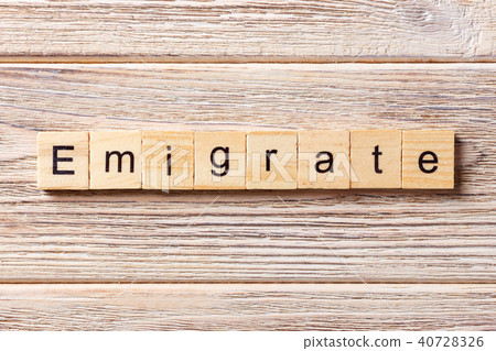 emigrate word written on wood block. emigrate word written on wood block. 40728326