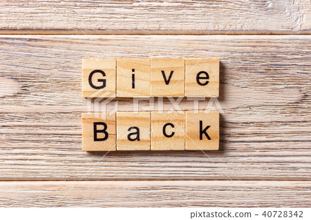 Give Back word written on wood block. Give Back word written on wood block. 40728342