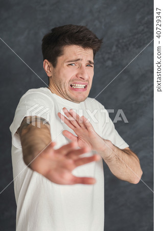 Young man expressing disgust, grimacing 40729347