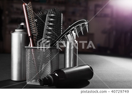flacons of hair sprays near a basket with hairbrushes flacons of hair sprays near a basket with hairbrushes 40729749