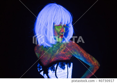 wedding in neon lighting in vogue style bride glows in the dark young girl with hairstyle quads and 40730917