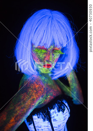 concept of wedding photosession in neon lighting in vogue style bride keeps hand near head glows in concept of wedding photosession in neon lighting in vogue style bride keeps hand near head glows in 40730930