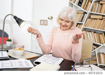 Glad mature woman solving task 40731633