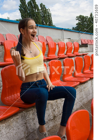 Teen girl supporter fan at the stadium game Teen girl supporter fan at the stadium game 40731689