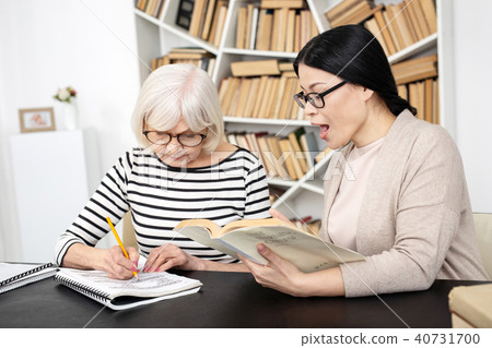 Beautiful tutor having lesson with senior woman 40731700
