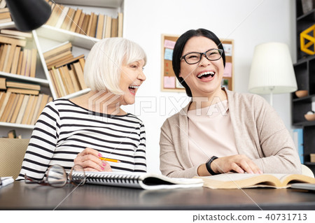 Joyful woman tutoring to senior woman 40731713