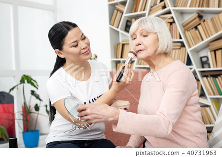 Attractive volunteer perfecting senior woman face 40731963