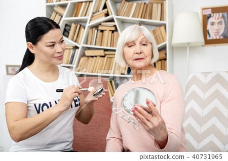 Charming mature woman admiring her face 40731965