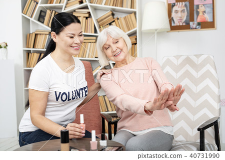 Vigorous senior woman admiring manicure Vigorous senior woman admiring manicure 40731990